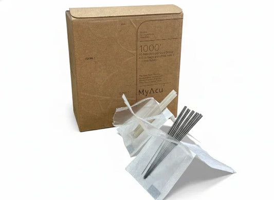 Cardboard box with MyAcu branding, containing acupuncture needles and accessories on a white background.